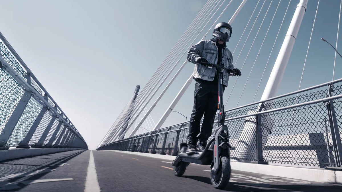 Personne roulant sur un pont avec la trottinette électrique Segway GT3 E